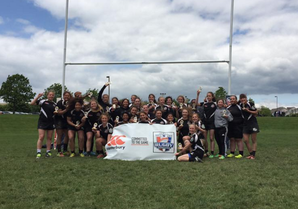 The State College Girls Rugby Team smile with their trophies after winning the State Championship.
