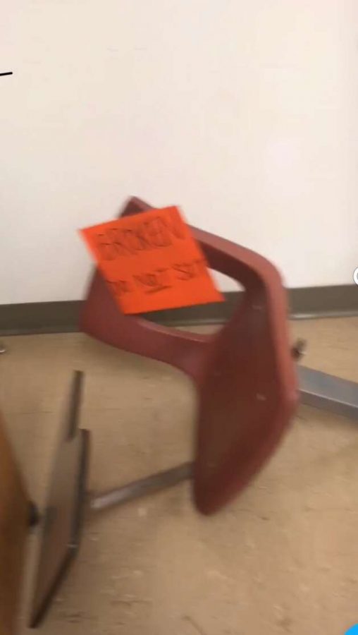 Picture of a fallen down and broken chair found in the south building. The sign on it reads, “BROKEN, do not sit.” Many of the language classrooms used chairs like these in their classrooms. Pictured by Jake Cooper.
