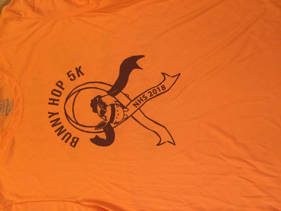 Pictured above is the t-shirt design for the National Honor Society’s Bunny Hop 5k. They chose to use the ribbon as a symbol for cancer research. Freshman Kyra Whitlark said, “I didn’t love the orange but it obviously meant something important and was symbolic towards the cause.” The orange ribbon has been known to symbolize kidney cancer.