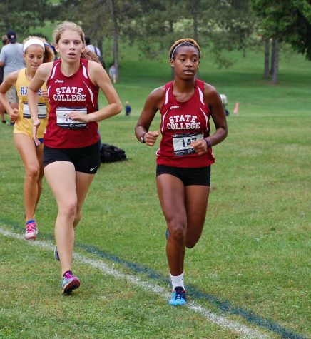 State High runners Senior Emma Simon and Junior Mihret Strauss run during the Spike Shoe Invitational. Strauss describes how she prepares for a meet, “I think about all the meets that I’ve done and that has made me work harder. I think about my family when I’m running and that makes me push harder”(Pictured on the right).