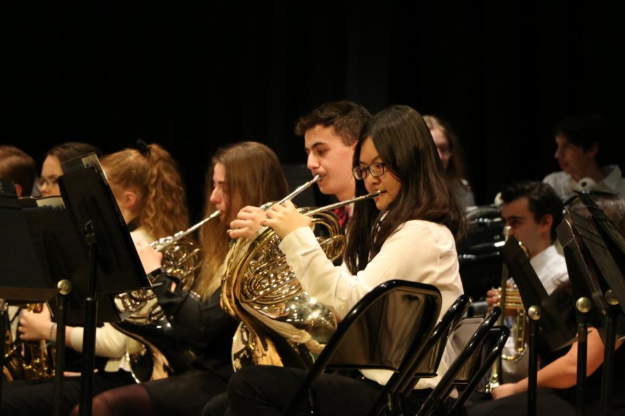 Heejung Koo, sophomore French horn player, plays her French horn during the Concert band concert. Koo said her favorite part about being in the Concert band is, the people. You get to connect with so many people.
