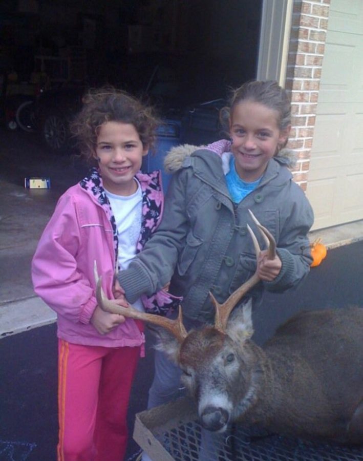 Sophomore Jacquie Gordon (left) and junior Jess Gordon (right) pose with a buck in 2009. The Gordons have been involved in the culture of hunting for the majority of their lives. I have been going out in the woods with my dad since I was about 8 years old, Jess said.