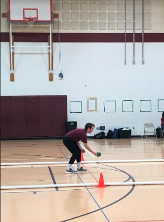 Elliot Sheehan, a junior at State High,  rolling the bocce ball during his turn. Sheehan said, "The Bocce Ball Match was such a great experince, full of learning,  meeting new people, and helping his fellow classmates.  I am definitely going to be a participant on the bocce ball team next year in 2020."