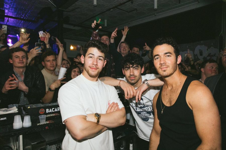 The Jonas Brothers posing at Champs Downtown. The group bought everyone drinks on that night.