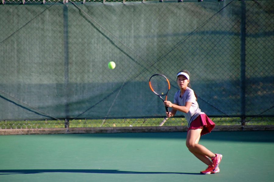 Quiana Guo, freshman, plays singles during the State High Girls Tennis Teams’ semi-final district match against Hollidaysburg. Quiana describes what she learned during her first year on the team. “I feel like another thing I’ve learned is that the people on the team are willing to help no matter what. It is just so nice and helpful to know that 20 some people will always be there to back you up,” Guo said. 

