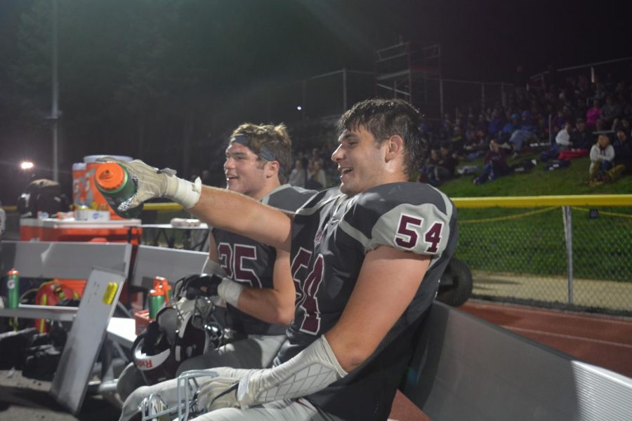 State High Football teammates Bryn Schoonover and Ryan Domico cheer on the rest of their team during a game.