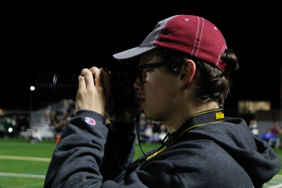 Caleb Craig, photographer, gets ready to snap an action shot of the State High vs. Central Dauphin game. 