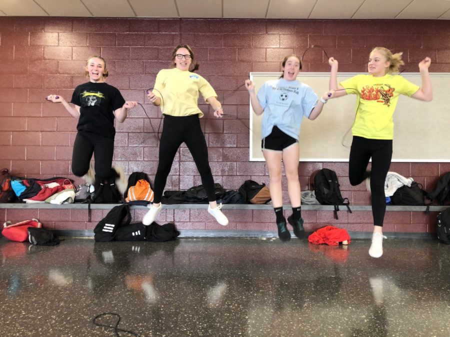 (left to right) Lila Mathias, Zia Bodnar, Ella McDyre, and Grace Lippinoctt complete a warm up of jump rope. My least favorite activity is definitely jump rope (@Lila Mathias), McDyre said. Workouts consisted of a 10 minute warm up, 30 minute strength training, and 15 minutes of core.