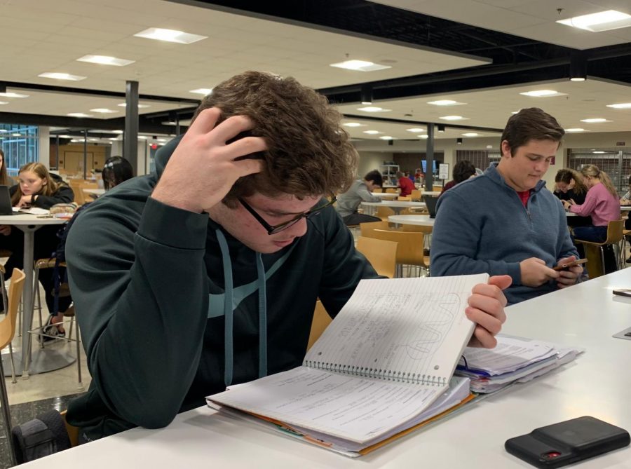 Ryan Domico, sophomore, studies during his cafeteria study hall. Nationally, students have reported high levels of stress due to school. “It’s kind of ‘cool’ to be stressed nowadays,” Merel Padt, senior, said.
