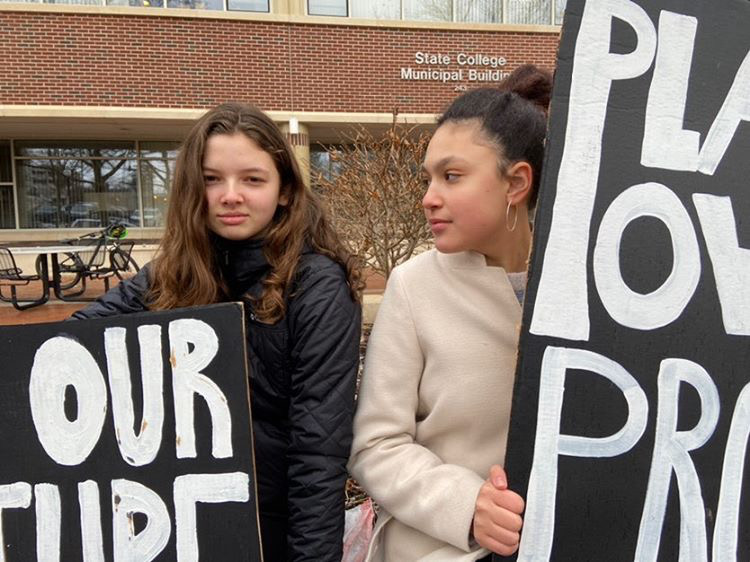 Two Delta students, Lena Logan Adams and Miranda Marks strike outside the Municipal Building on a Friday walkout. Even in cold weather, these girls leave school to make their beliefs heard. 