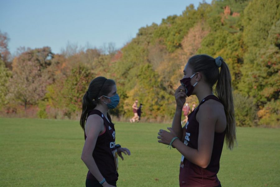 Seconds after crossing the finish line, senior Jordan Reed (left) and sophomore Marlee Kwasnica (right) wait for the rest of their teammates to complete their race in State College, PA, taken Oct. 13, 2020.
