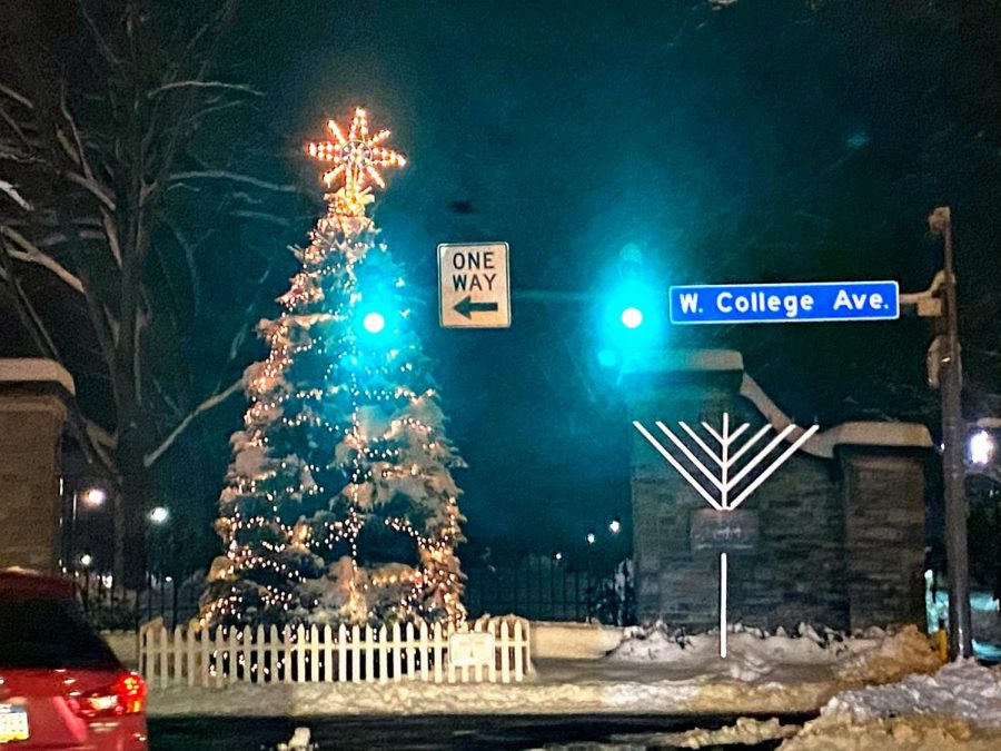 A lit up Christmas tree and a Menorah standing tall in downtown State College, on display for everyone to see. 