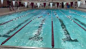 Members of the State High Swim and Dive team practice in the State High natatorium. 