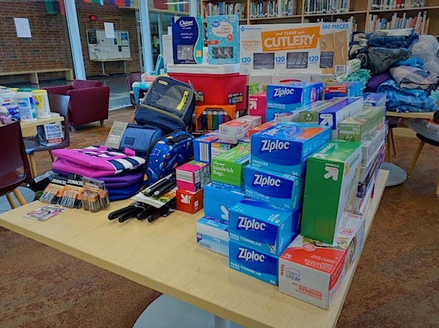 Products like Ziploc bags, batteries, cutlery, lunch bags and more after being sorted into donation categories in the library at State High. 