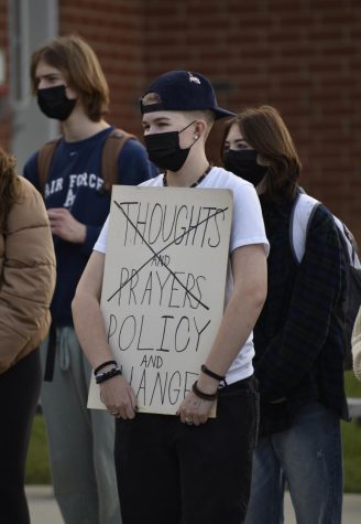Sophomore Phoebe Henry holds a sign reading Thoughts and Prayers, Policy and Change, with the former phrase being crossed out at the student-led walkout on Thursday, Dec. 16. 