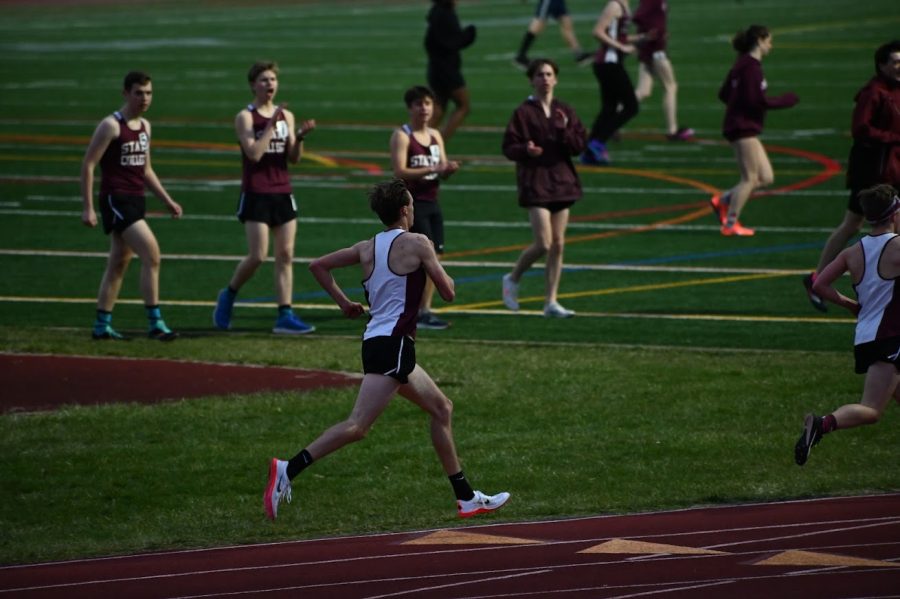 An image of State High senior Trent Dinant about to finish a race during a track meet.