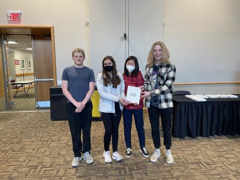 State High Pi-Thon Wranglers (consisting of sophomore Trevor Martin and seniors Serena Duncan, Christina Wang, and Ben Rider) pose with their fourth place plaque at the Bloomsburg Programming Contest on April 12, 2022.