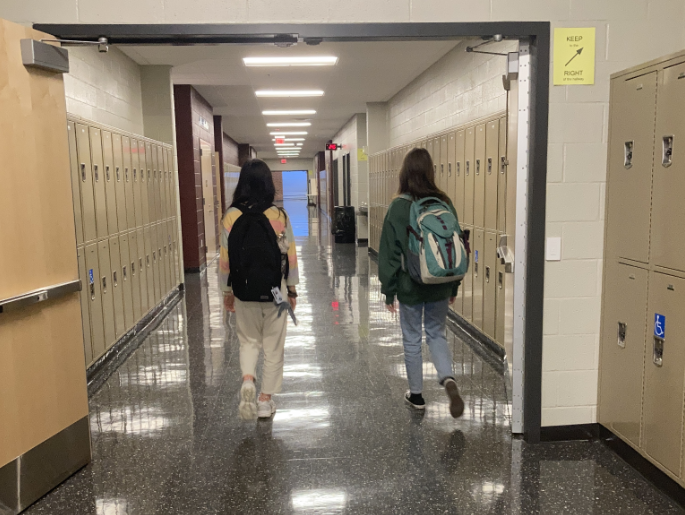 Two freshmen walk together down the E pod hallway, ready to face their next class.