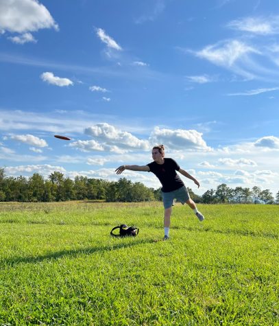 Zack Aneckstein, co-founder of the Disc Golf team, mid-throw as he attempts a putt at Tri-Municipal Park.