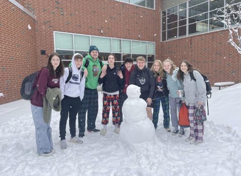 The Business Law class goes outside to build a snowman before winter break.  