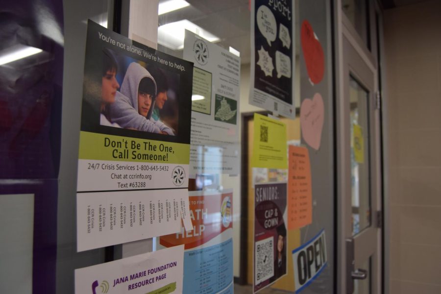A wall of resource posters outside of the State High counseling office.