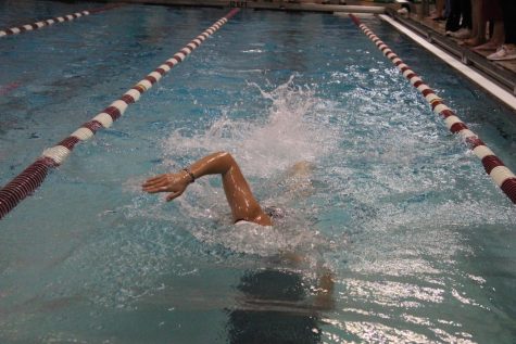 Senior Lydia Geiger completes the first 25 yards of the 100 yard freestyle. She went on to place sixth in the event and achieved a personal best time.