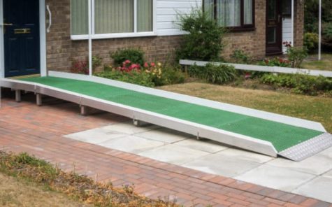 A green ramp provides an accessible access point to a doorway.