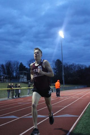 State College senior Nick Sloff chases after Carlisle senior Kevin Shank in a fast 3200 meter race. Sloff just passed through the first 1200 meters and would go on to finish second to Shank with a time of 10:01.