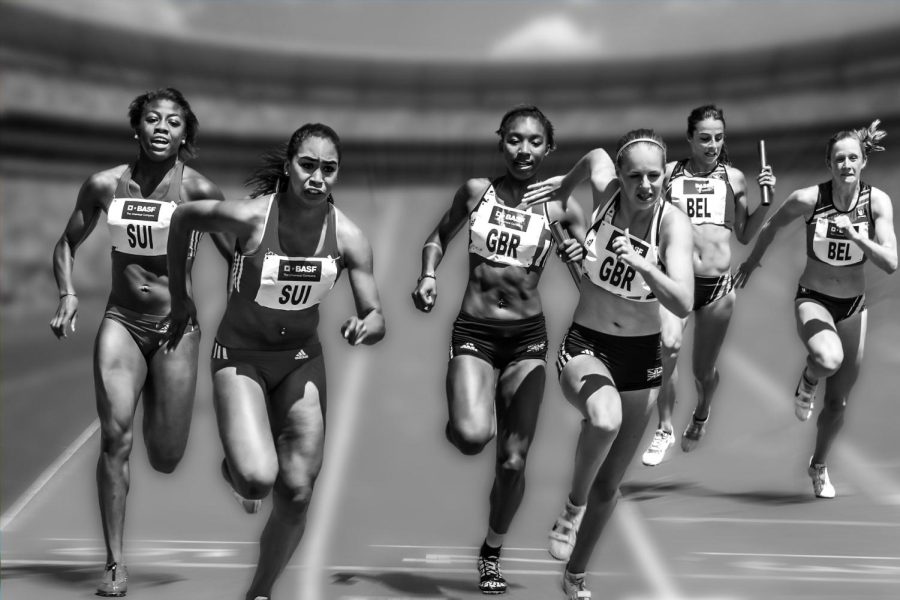 Several+women+competing+in+a+track+race+are+shown+handing+off+batons+to+teammates.+%0A