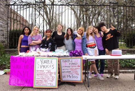 Purple Project organizers and volunteers at a fundraising bake sale in front of the Allen Street Gates. 
