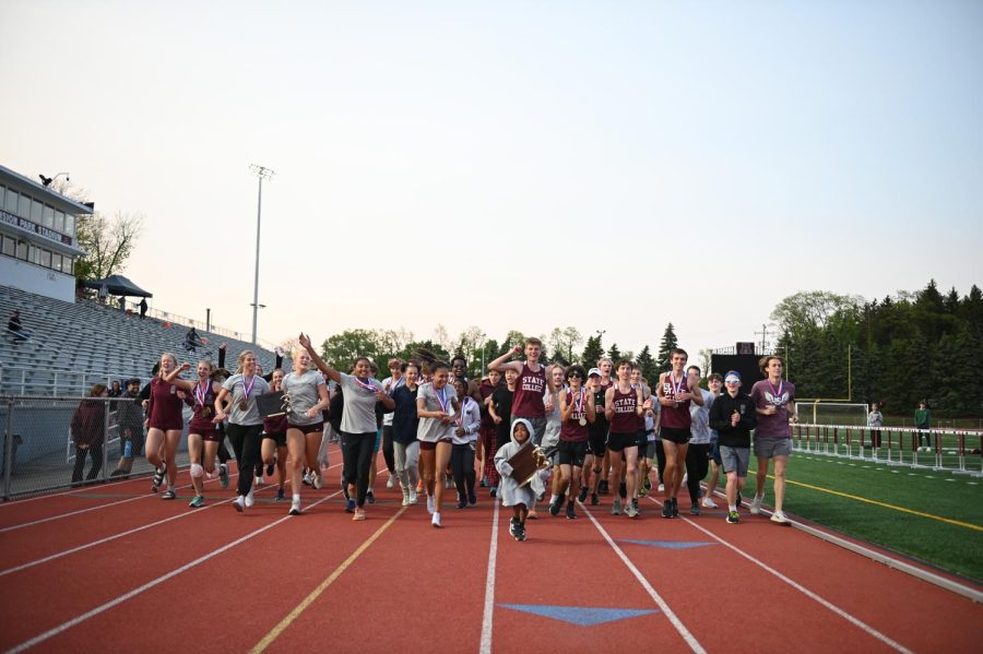 State+High+Track+and+Field+athletes+run+a+victory+lap+after+winning+the+District+6+Championships.