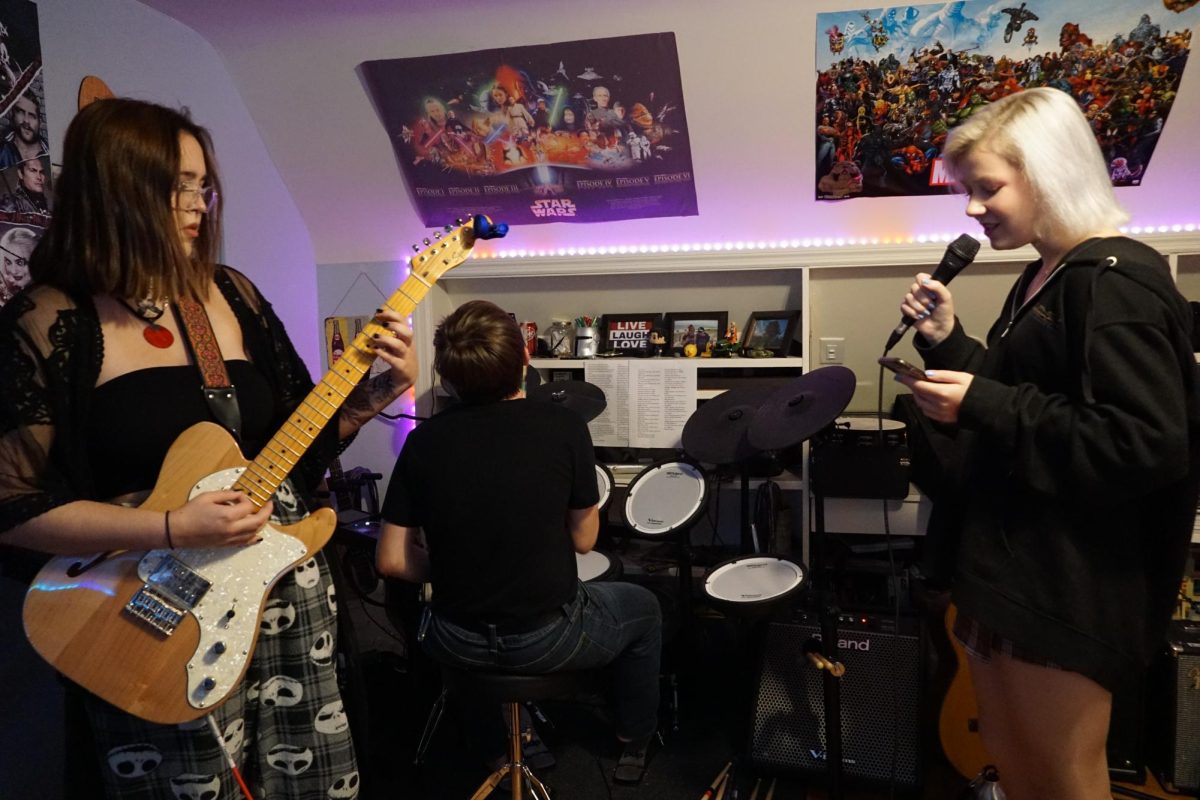 Poser Band rehearsal. Lead singer: Kate Schark, lead guitarist: Sofi Kovalenko, and drummer: Lucas Rittenhouse.