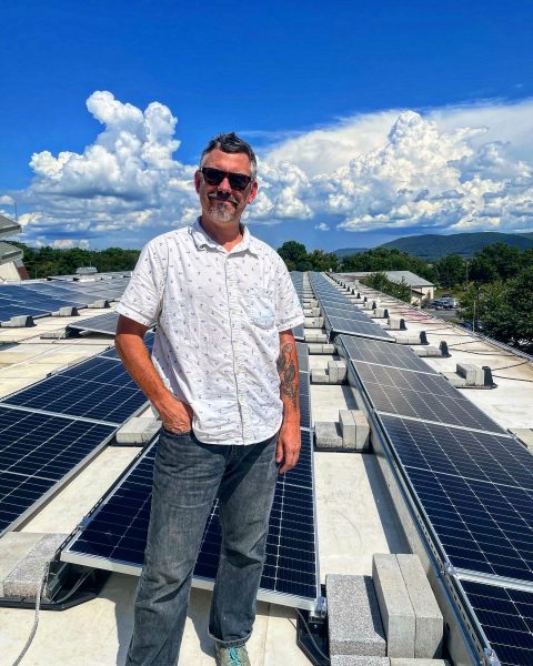 Dr. Buck on the rooftop solar array in Ferguson Township. Photo courtesy of Peter Buck. 