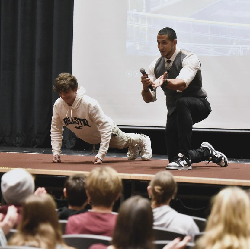 A student from Bellewood School District completes push-ups with the encouragement of the audience.