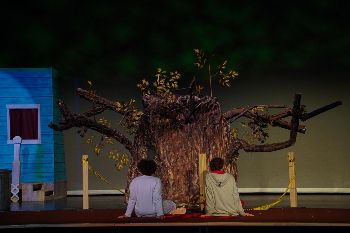  Samar (Whitney McMullen) and Stephen (Ryder Cunningham) listen to the wishing tree Red as he tells a story. 

