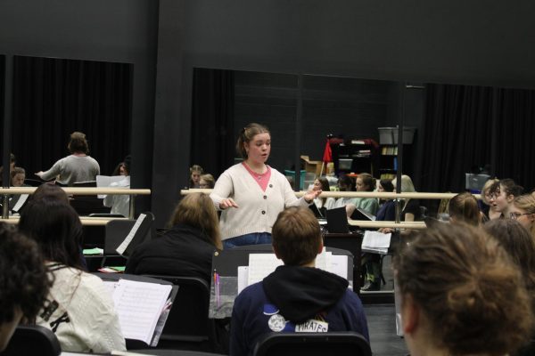 Gray Choir director Abby Putnam conducting rehearsal in the Black Box on Feb 1, 2024