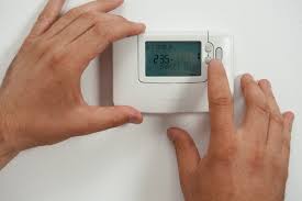 A thermostat being set