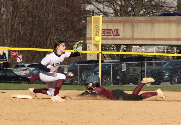 Sydney Wells sliding into second base to beat the throw from the Altoona catcher.