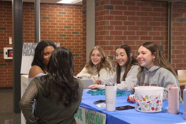 State High students visit a station set up in the cafeteria during the Mental Health Summit 