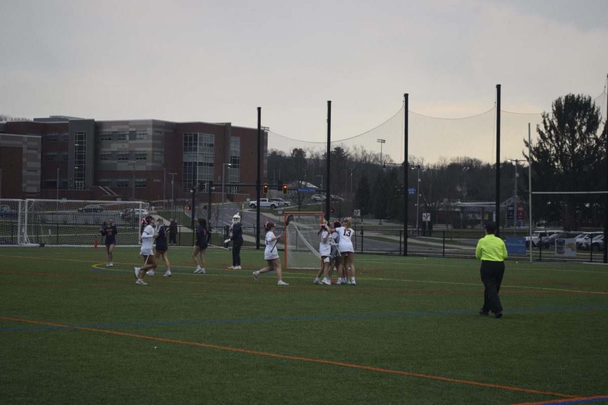Freshman Ella Gourley (#13) hugs her teammates and celebrates a score in their JV game vs. Hershey, Friday, March 22nd, 2024. 