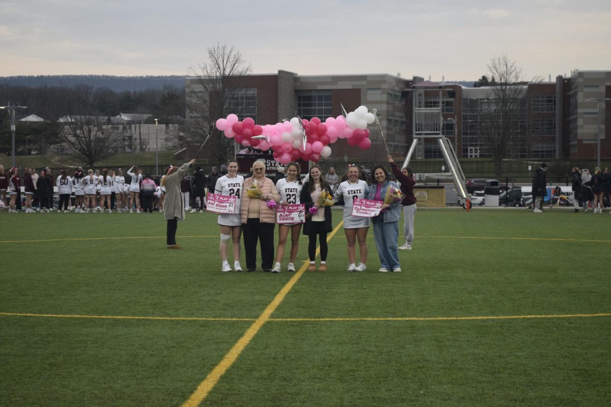 Senior, Katie Fry (left) brought her grandma, Sophomore, Mckenna Kulka (middle) brought her cousin, and Sophomore Lily Sidwell (right) brought her mother who has survived the fight against breast cancer to support their pink out game. 