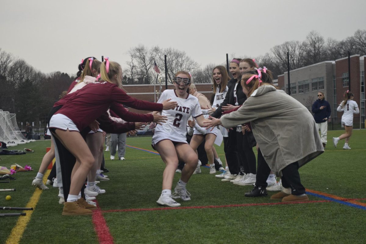 Junior Emma Lally (middle) high fives her teammates before their game against Hershey, Friday, March 22nd, 2024. 