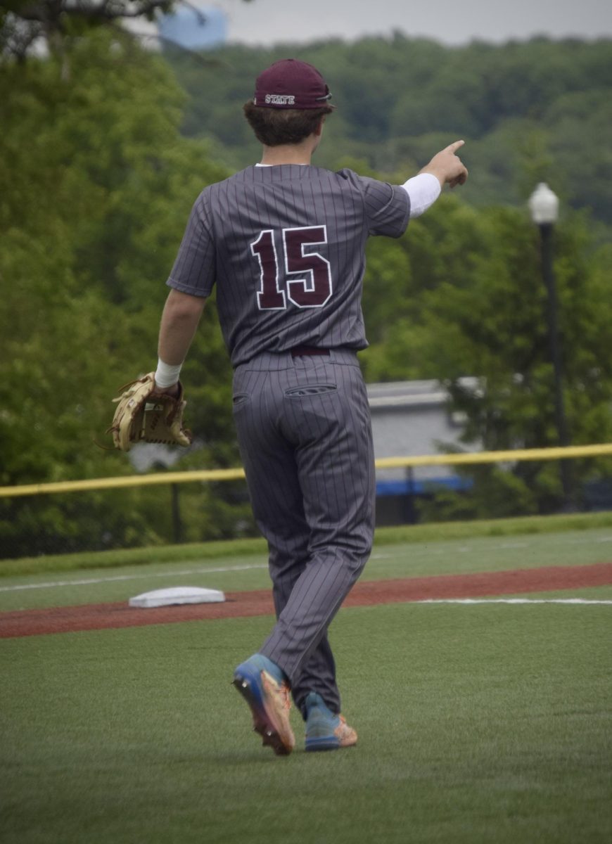 Senior Logan Shannon directs traffic from third base in the third inning.
