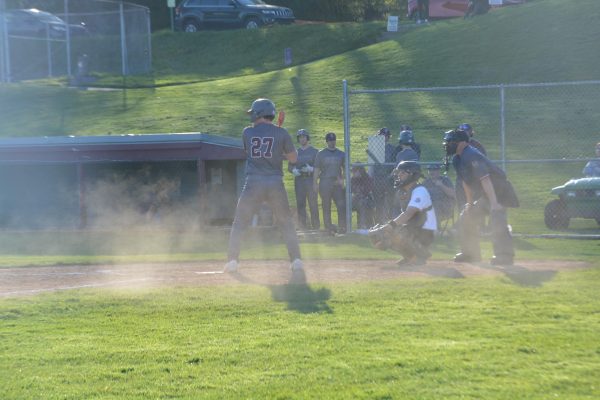 Dust flies after a strike for State, while batter revs up for the best hit of the game.