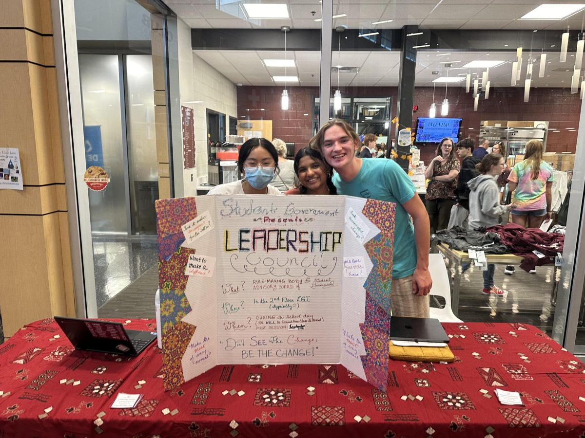 Grace Yang (left), Nubah (middle), and Luca Snyder (right) present what leadership council is about at club fair. Photo courtesy of Grace Yang. 