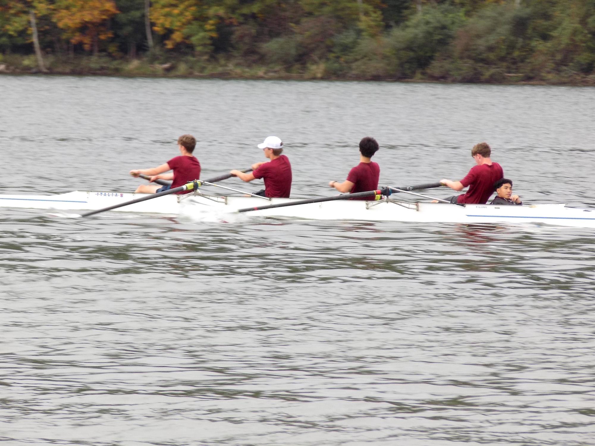 Seniors Micah Langelaan, Nolan Setcavage, junior Issac Tan and sophomore Liam Hickman swiftly row during their competition.