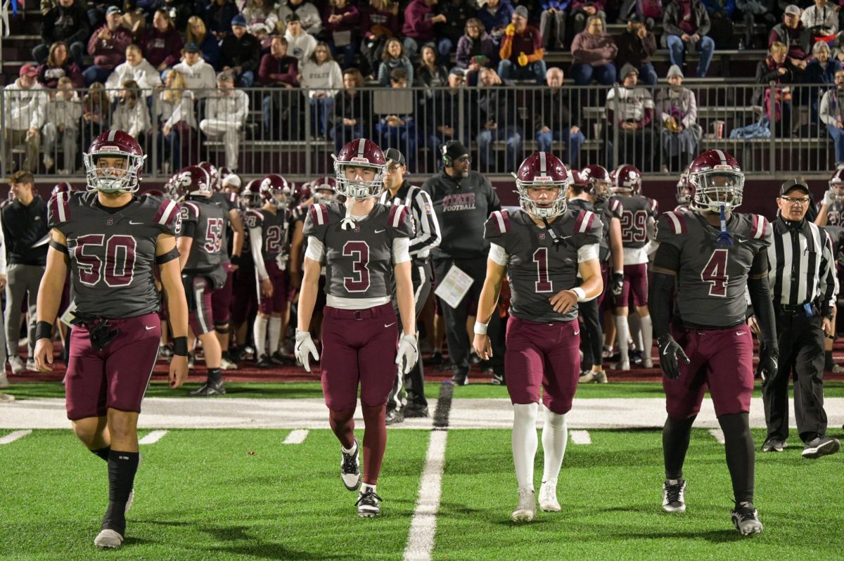 Captains Sam Mayer, Ty Salazer, Cooper Brushwood, and Lamar Wilson walk out onto the field prior to a game.