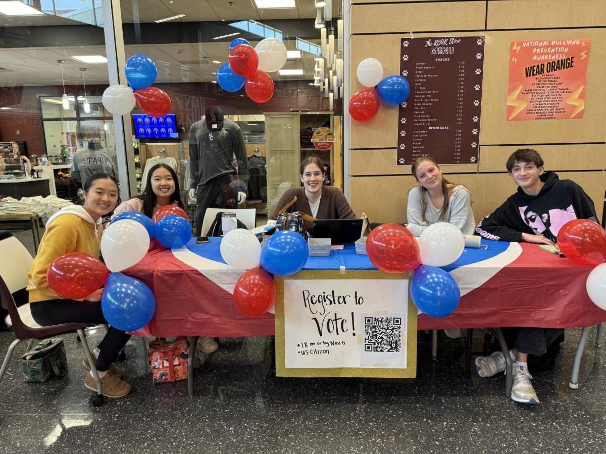 Members sitting at the voter registration booth in the hub during lunch to encourage State High students to register for the upcoming presidential election. Photo courtesy of Ashley Corvin.