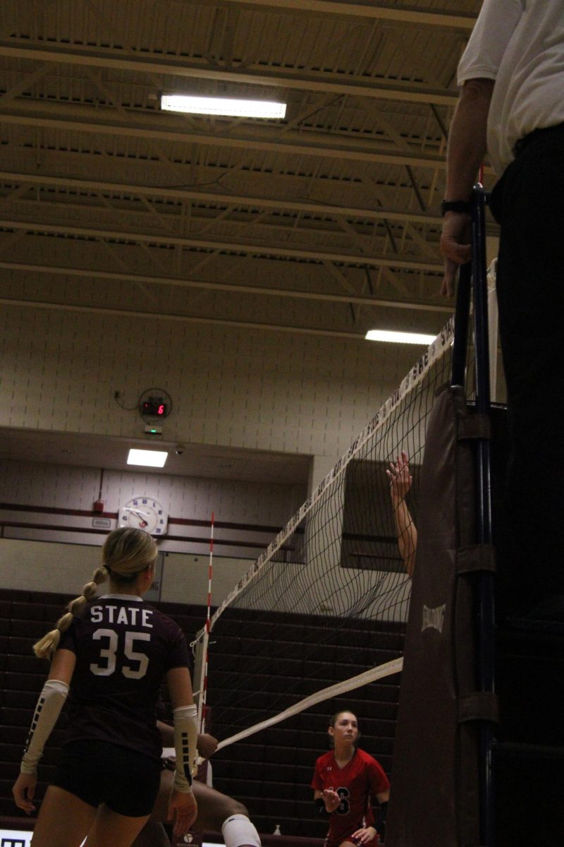 Junior Harper Campbell (35) prepares to block early in the first set. She is wearing a maroon shirt with number#35