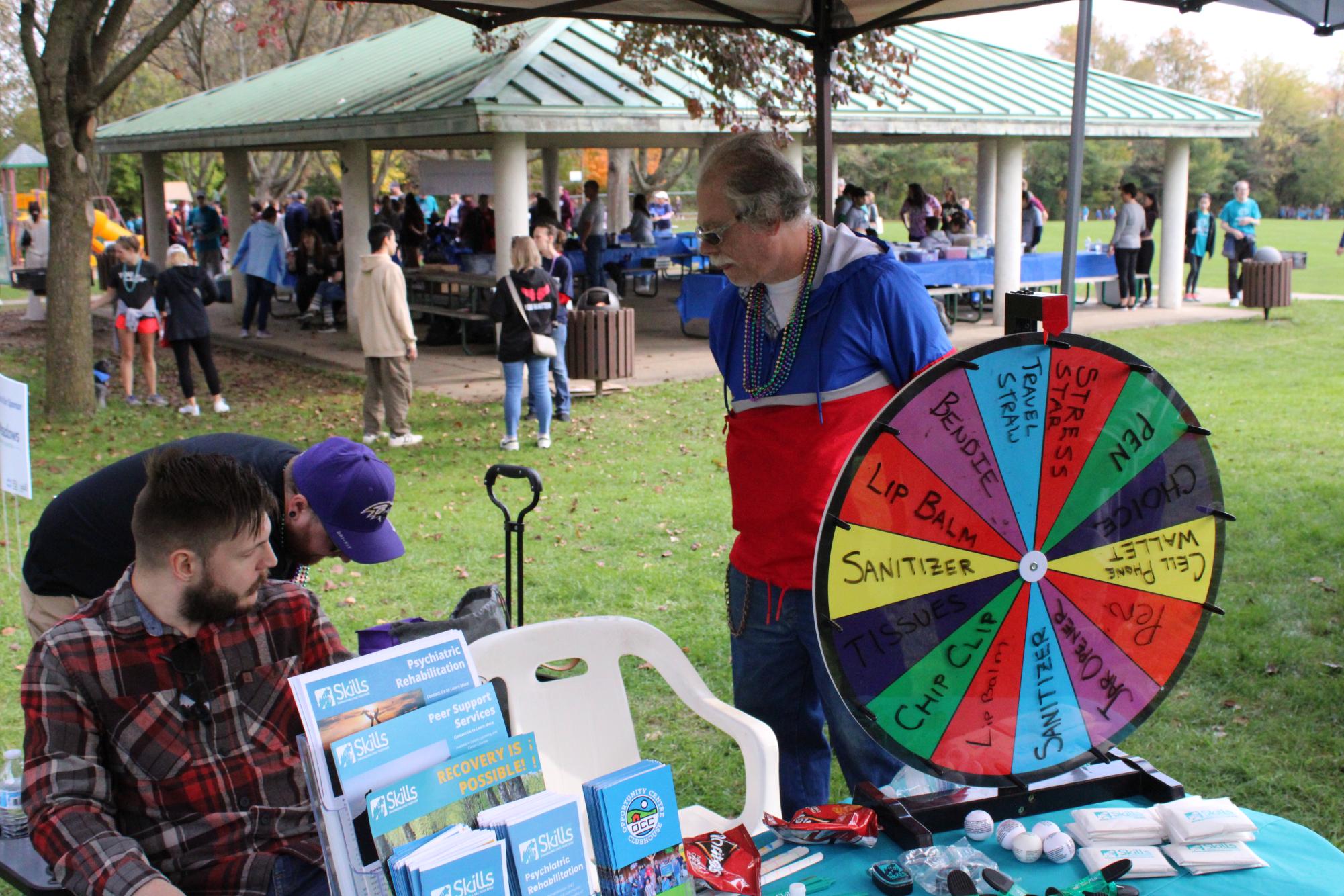 One of many activities offered at the Out Of The Darkness Walk on Sunday, Oct 13. If you were to spin the wheel, you would win a free prize to take home with you. In the picture, a wheel is shown along with various prizes listed that participants can win.